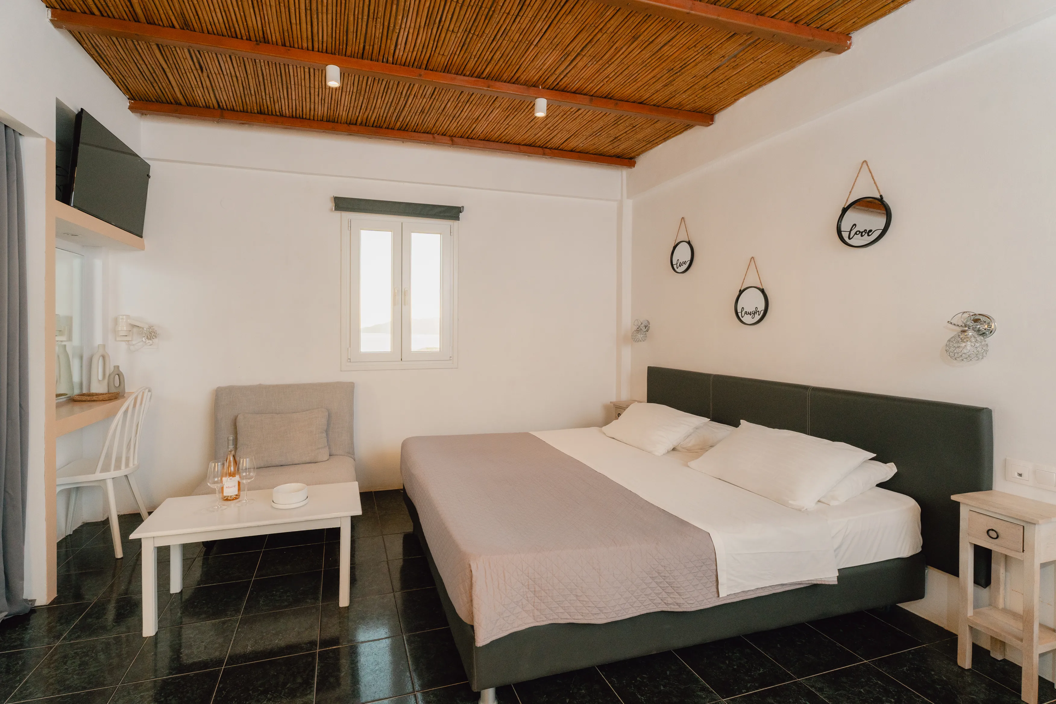 SkalaSunset comfort studio bedroom with double bed and wood ceiling