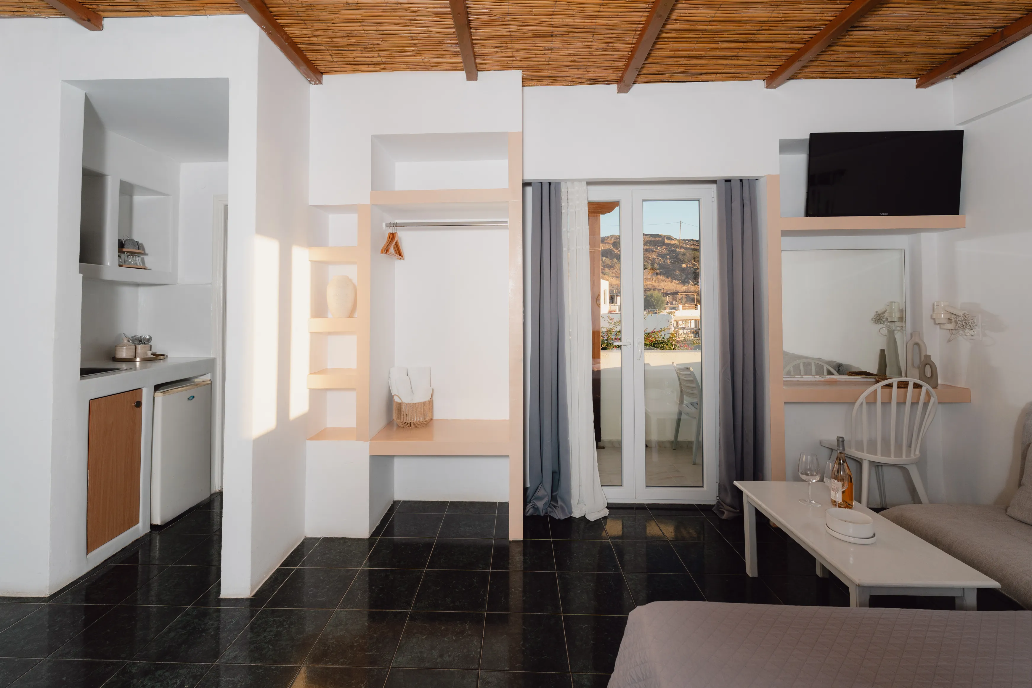 SkalaSunset deluxe double room interior with kitchenette and terrace doors