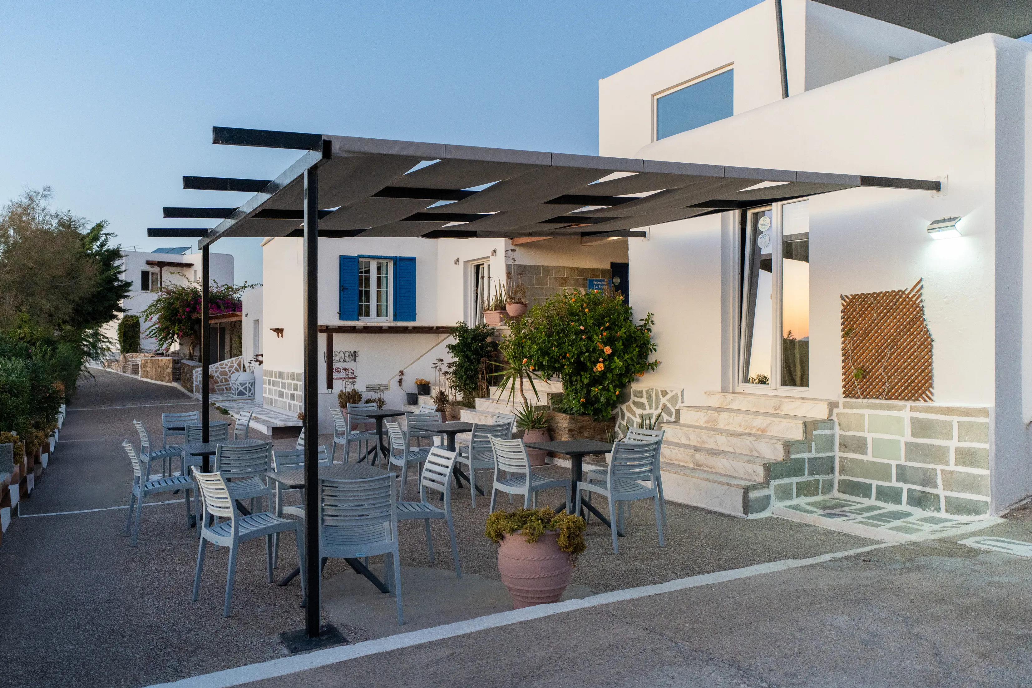SkalaSunset outdoor breakfast terrace with pergola and seating in Ios
