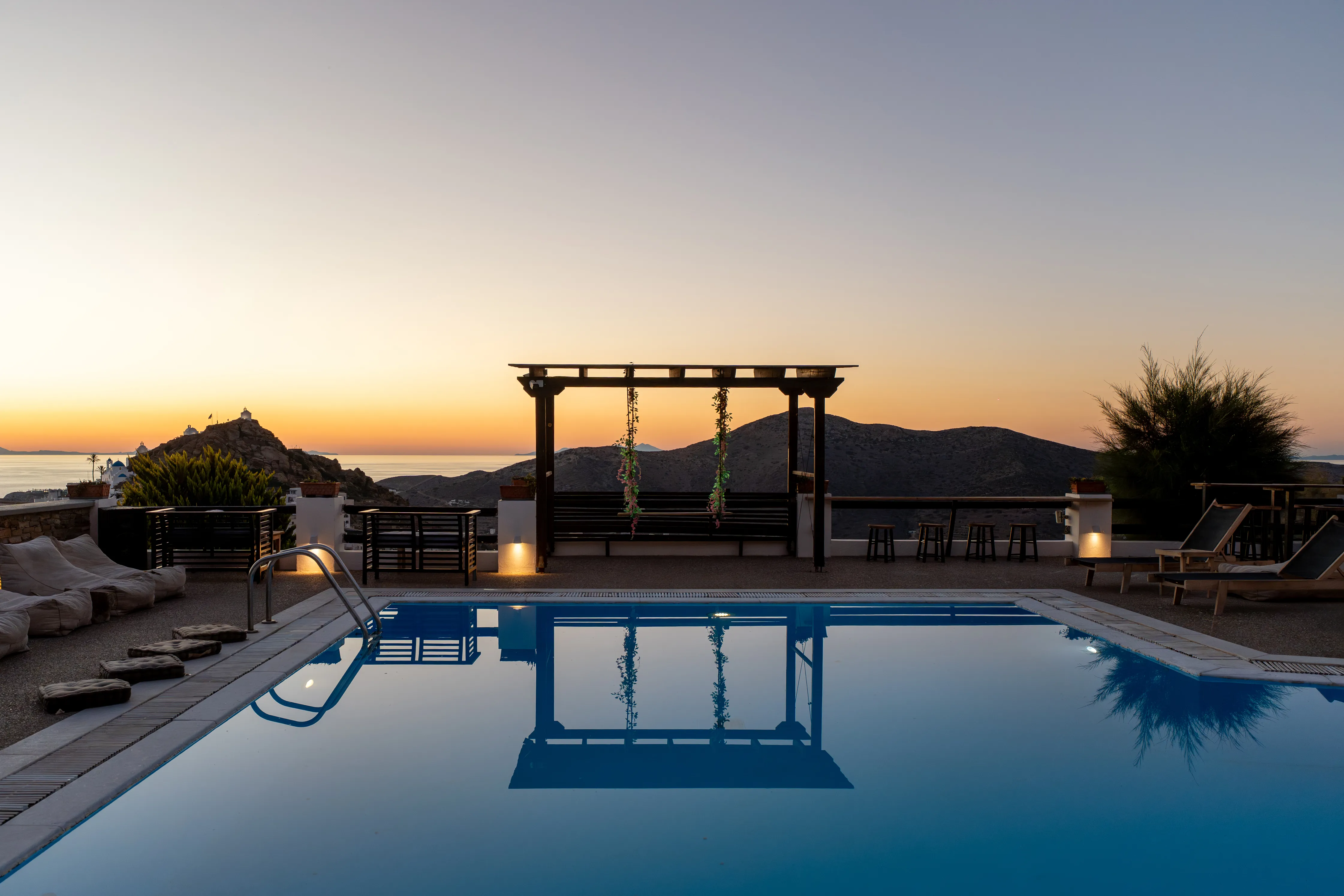 SkalaSunset swimming pool reflecting the sunset sky above Ios