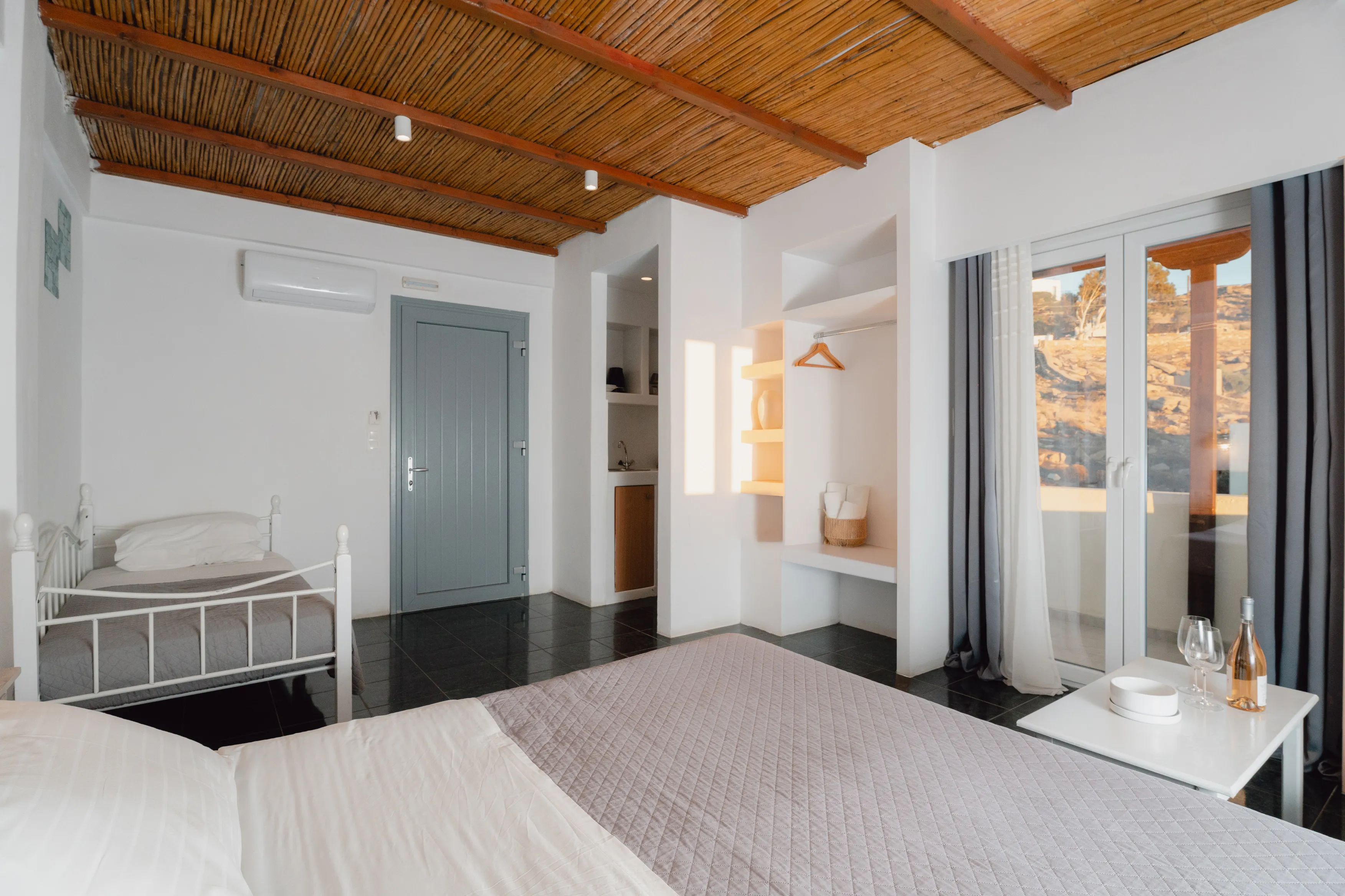 SkalaSunset triple room with double bed and single bed in bright interior