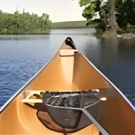 SkalaSunset canoe on calm river water stock image